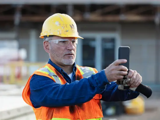 construction working taking a photo of a job