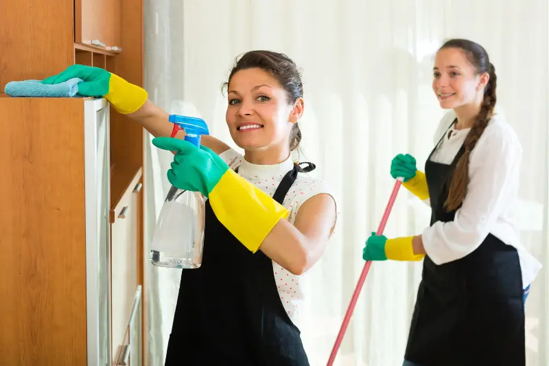 two women cleaning a house