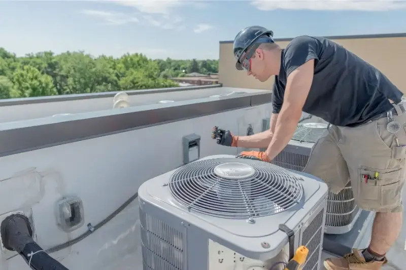 hvac technician working on roof unit